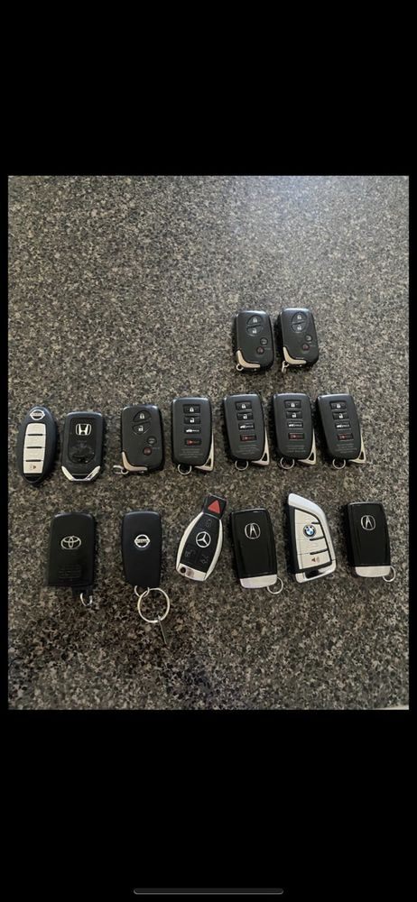 A neat layout of assorted car keys and remote fobs from different makes