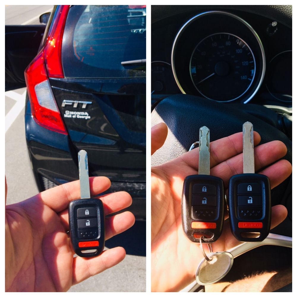 Honda Fit remote head keys held beside the car and the dashboard