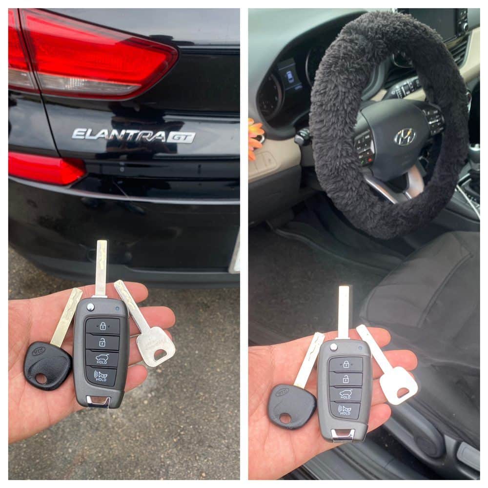 Hyundai Elantra flip keys with their blades extended, held in front of the car