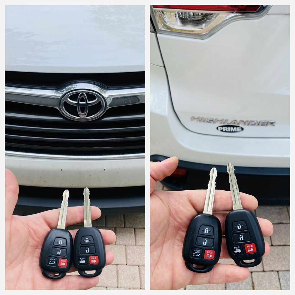 Two Toyota remote head keys held in front of a Toyota Highlander in South Florida